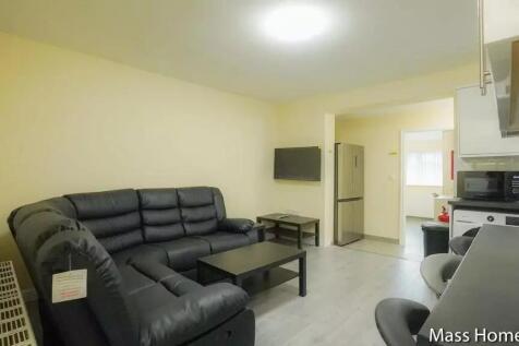 A modern living room featuring a spacious black...
