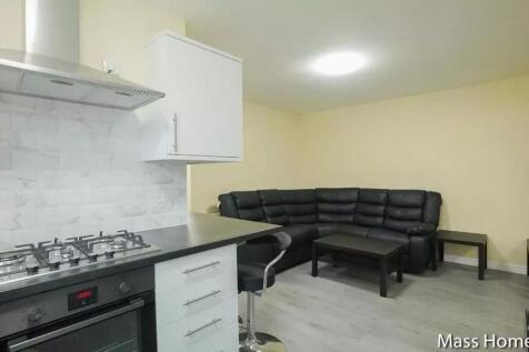 Spacious living area featuring a modern kitchen...
