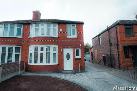 A charming semi-detached red-brick house with d...