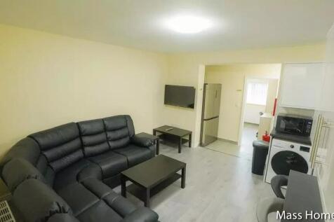 A neat and modern living room featuring a large...