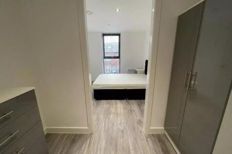 A modern double bedroom featuring sleek laminat...