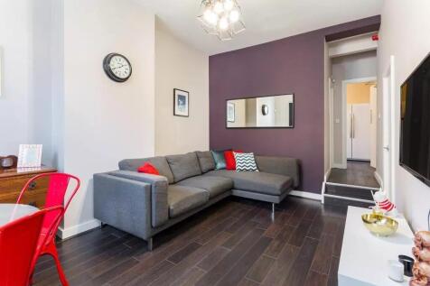 A modern living room featuring a stylish grey L...