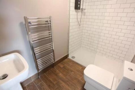 Modern bathroom featuring a sleek walk-in showe...