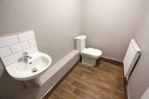 A clean and modern single toilet room featuring...