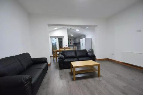 Spacious and modern living room featuring comfo...