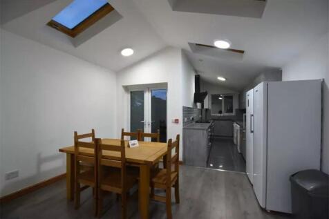 Bright and modern kitchen with skylights and Fr...