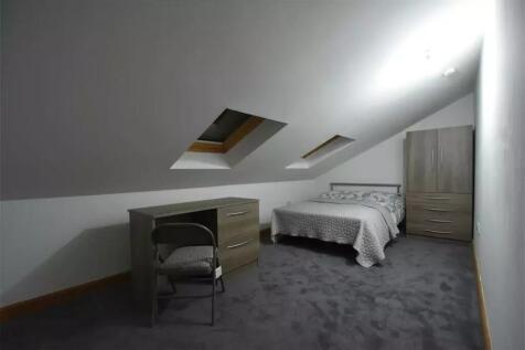 A cozy attic double bedroom featuring two skyli...