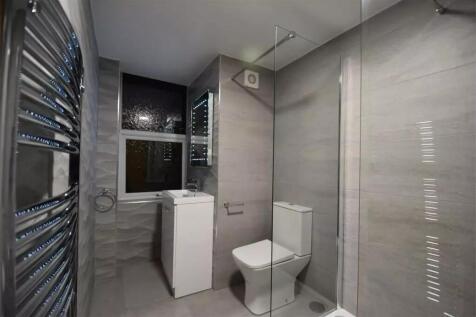 Modern bathroom featuring a sleek walk-in showe...