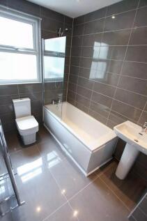 Bright and modern bathroom suite featuring slee...