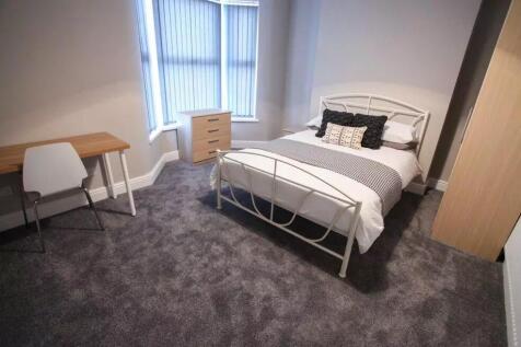 A bright and inviting double bedroom featuring ...