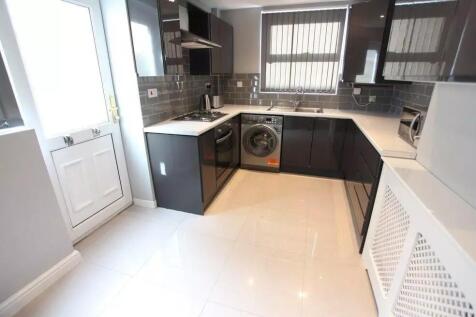 Bright and modern kitchen featuring sleek dark ...