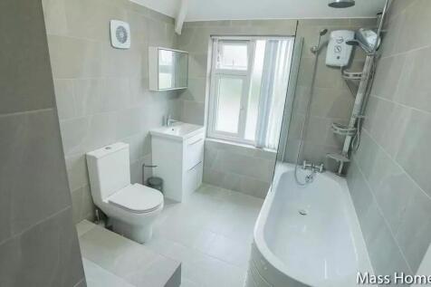 Bright and modern bathroom suite featuring a cl...