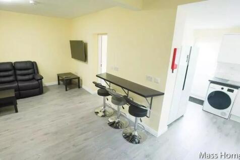 Bright and modern living room featuring a comfo...