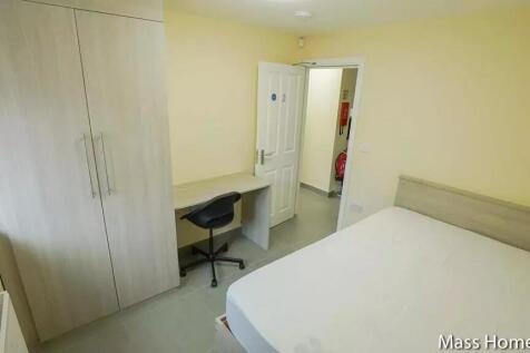 A tidy and well-lit double bedroom featuring a ...