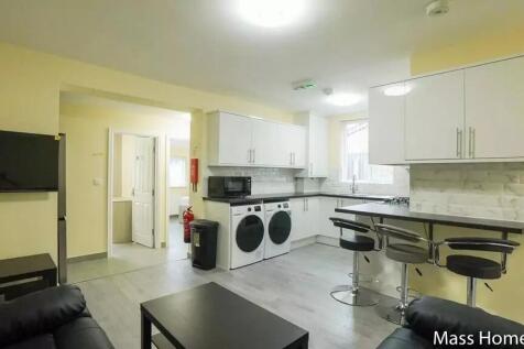 Bright and modern kitchen with contemporary cab...