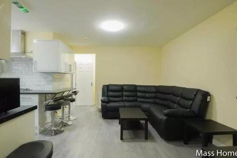 Contemporary living room featuring a sleek blac...