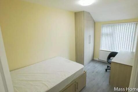 A tidy and well-lit single bedroom featuring a ...