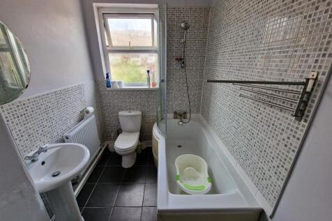 A clean and modern bathroom featuring a full ba...