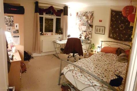 Cozy and inviting single bedroom featuring a me...