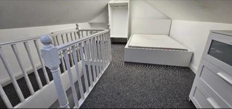Bright and clean attic space featuring a simple...