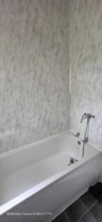 Bright and clean bathroom featuring a large whi...