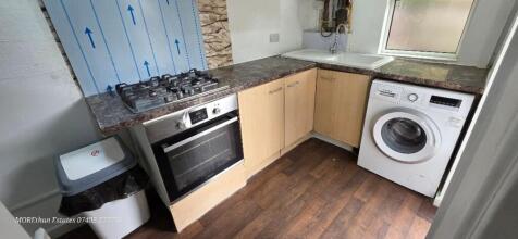 A compact kitchen with modern appliances includ...
