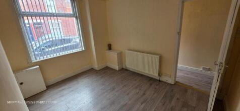 A well-maintained room with neutral walls and w...