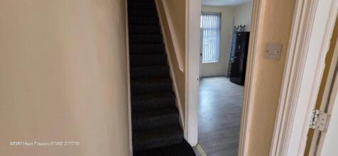 A clean and well-maintained hallway featuring c...