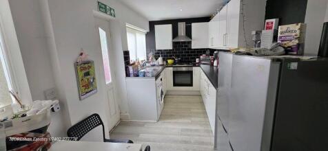 Bright and modern kitchen with sleek white cabi...