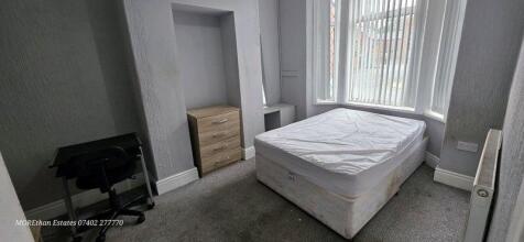A simple double bedroom featuring a comfortable...