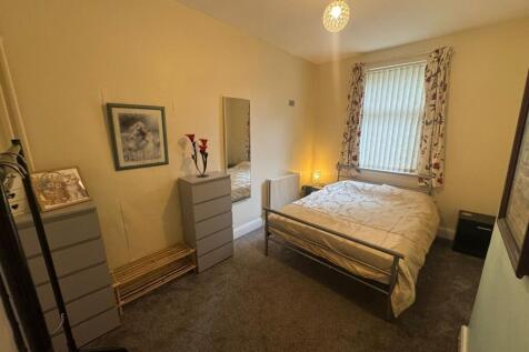 Cozy double bedroom featuring a comfortable bed...