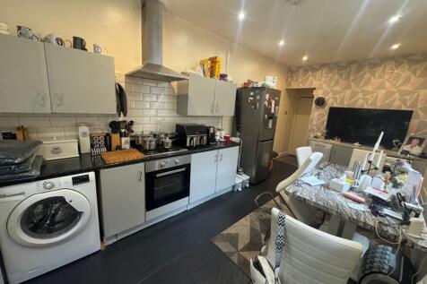 Modern kitchen featuring integrated appliances,...