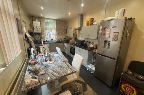 A functional kitchen featuring a dining table w...