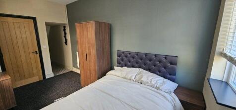 Bright and tidy double bedroom featuring a comf...