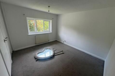A bright and spacious double bedroom featuring ...