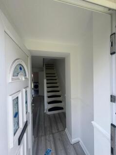 Bright and clean hallway with modern flooring a...