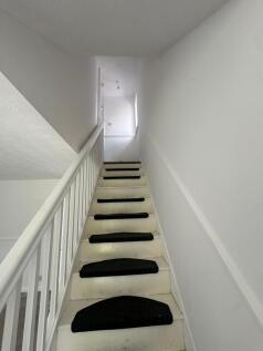 Bright and clean staircase with white walls and...