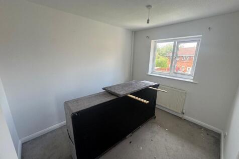 A small, well-lit room with a window that provi...