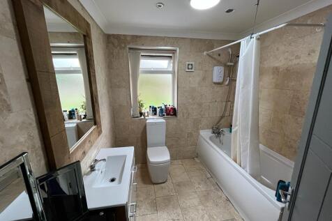 A modern bathroom suite featuring a clean batht...