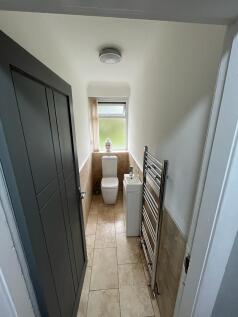 Bright and modern single toilet featuring a fro...