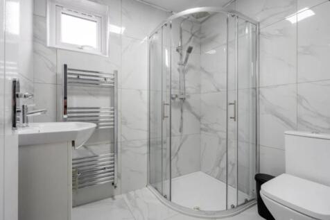 A modern bathroom featuring a stylish shower en...