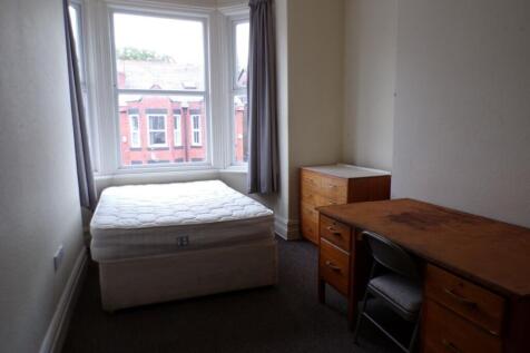 Spacious double bedroom featuring large windows...