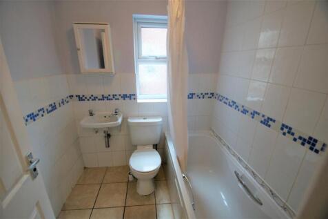 Bright and tidy bathroom featuring a clean bath...