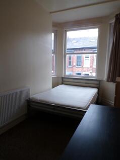 A bright and cozy double bedroom with large win...