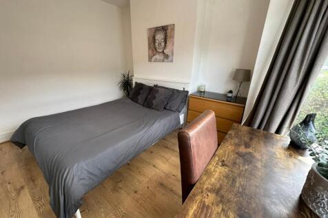 This stylish double bedroom features a comforta...