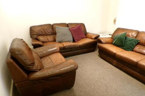 A cozy living room with comfortable seating, pe...