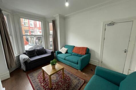 A bright and welcoming living room featuring la...