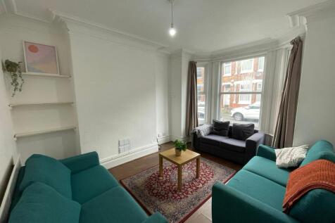 Bright and welcoming living room with ample nat...