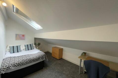 Bright and cozy bedroom with a skylight window ...