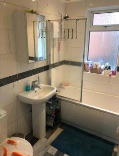 A well-maintained bathroom featuring a modern b...